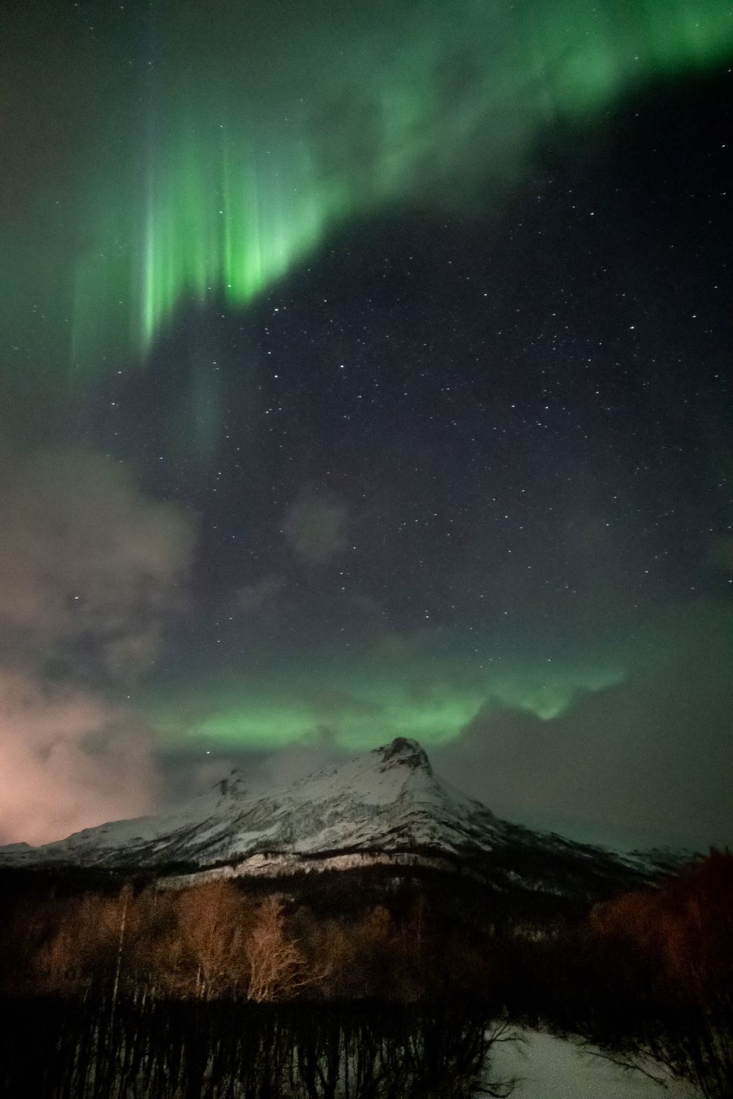 The northern lights over the mountains. Worth every cold mile