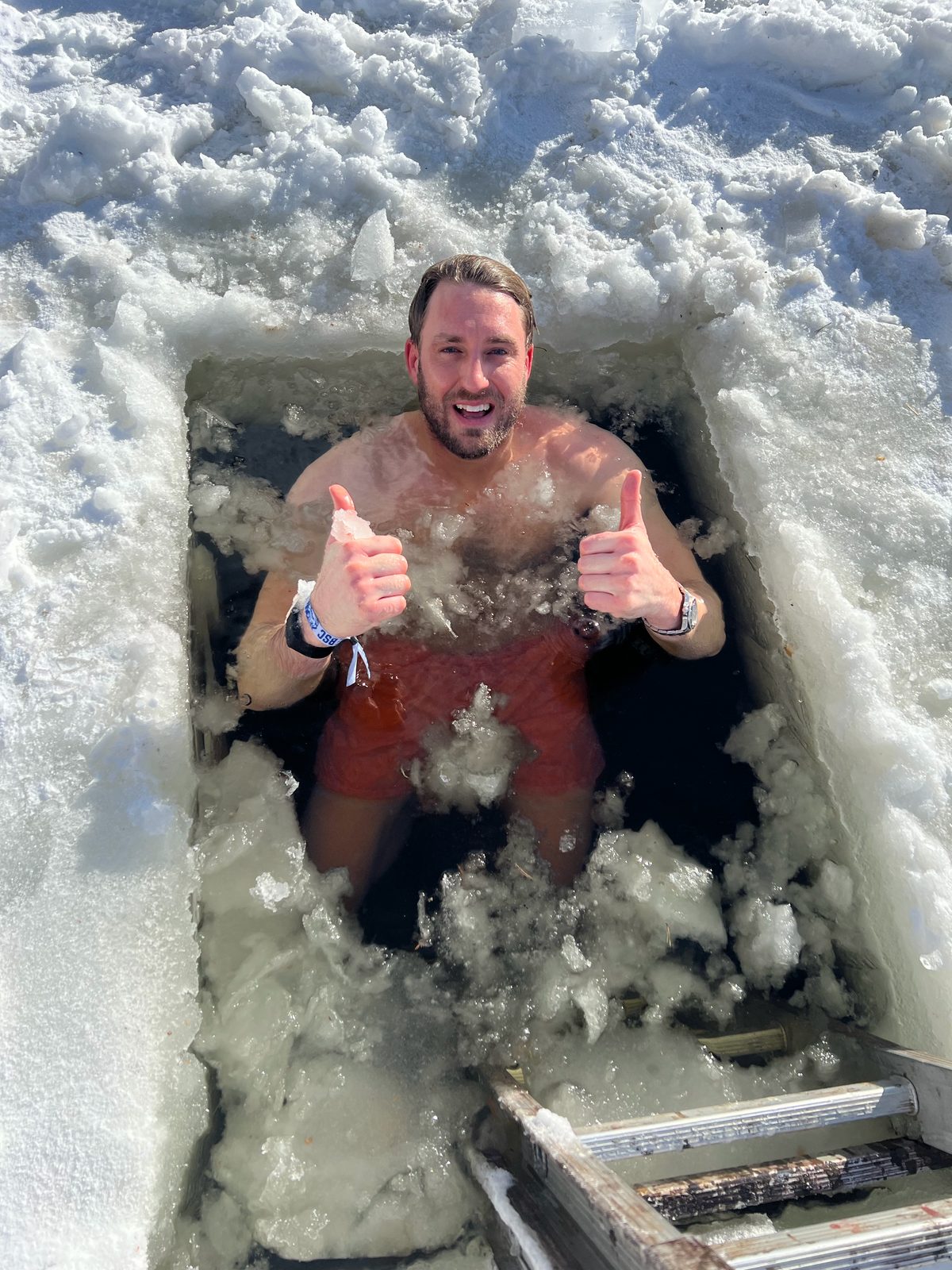 Thumbs up from a hole in the ice. Nobody was forced. Officially