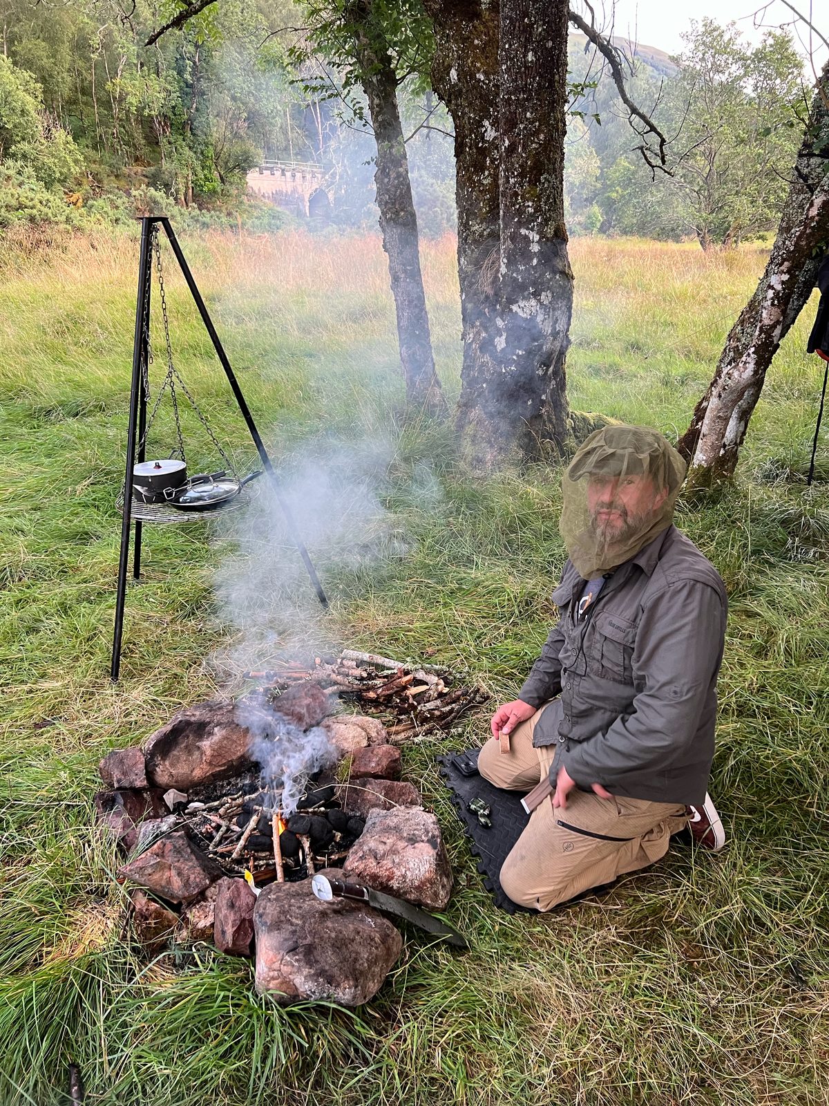 Bran by the fire, dressed for the midges. They had not been invited