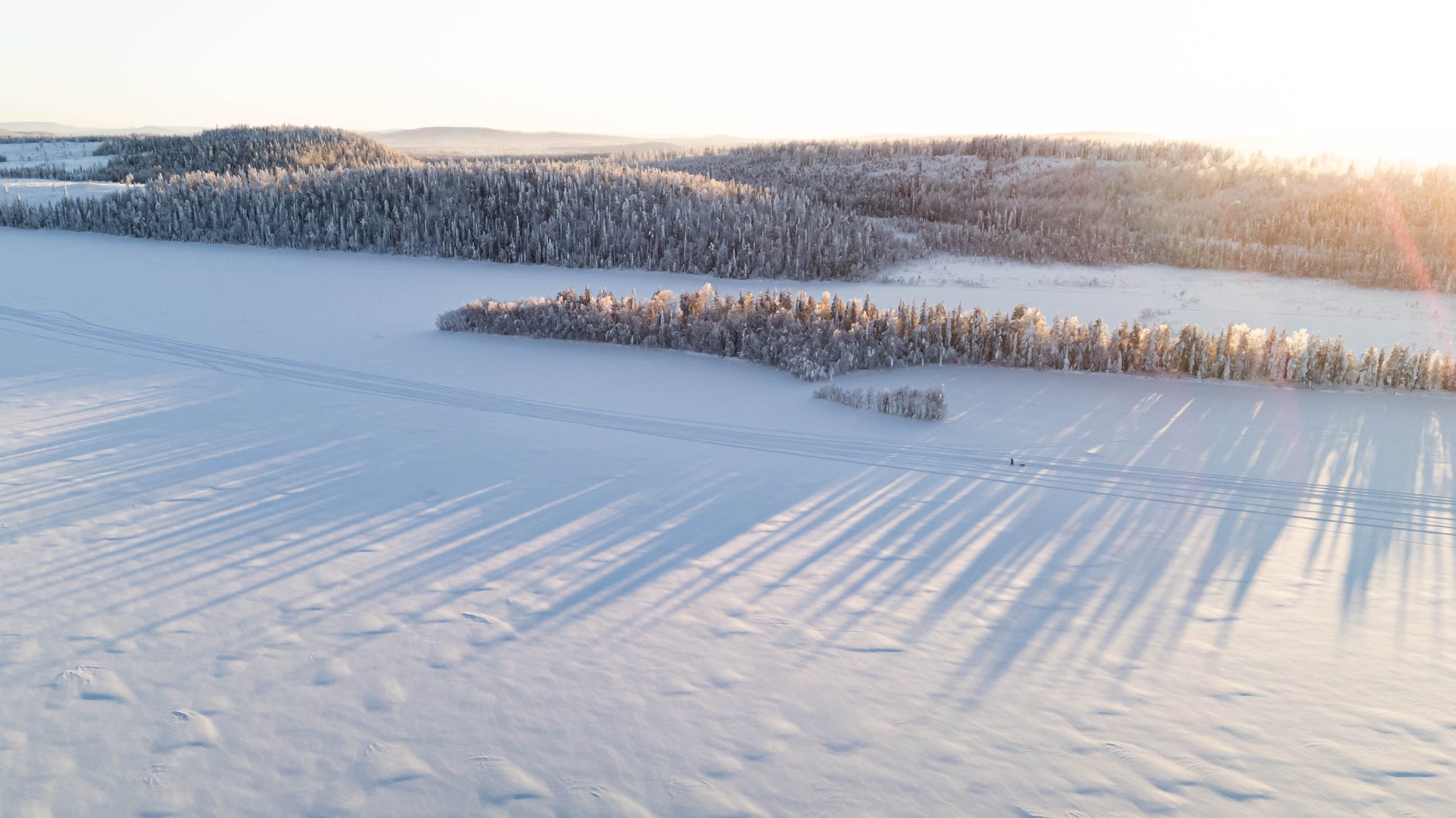 A frozen lake at golden hour on the Lapland Arctic Ultra 2026
