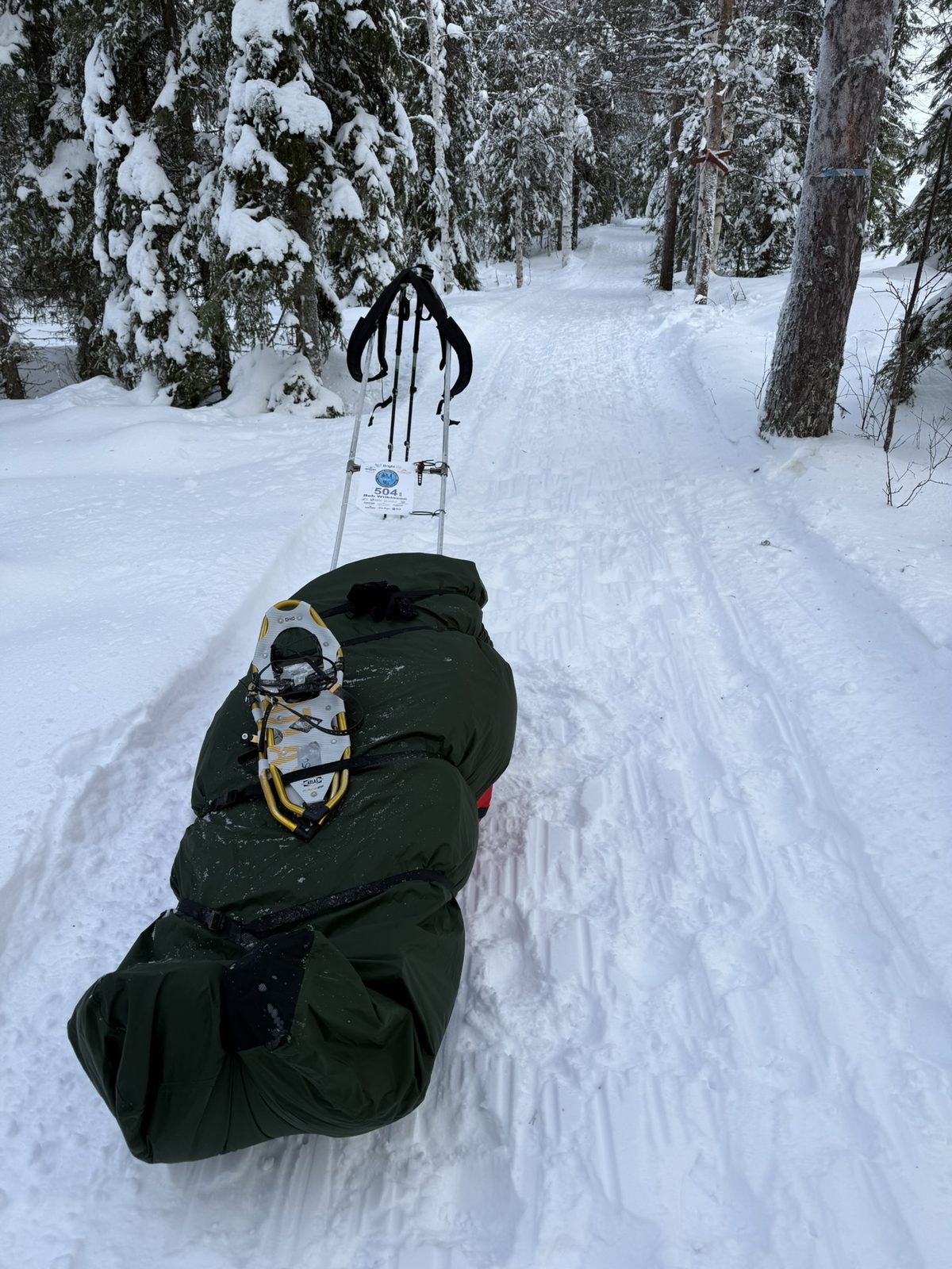 Lapland Arctic Ultra 2026: the sled, loaded, snowshoes on top. Heavier than it looks